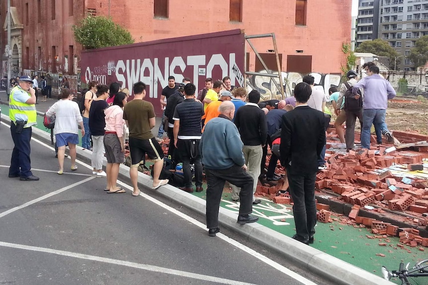 People flock to the scene of a fatal wall collapse on Swanston Street