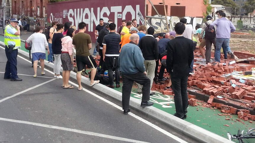 People flock to the scene of a fatal wall collapse on Swanston Street