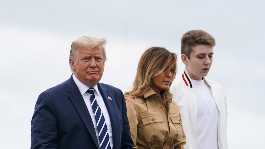 Donald, Melania and Barron walk along the tarmac to board Air Force One.