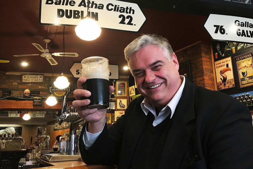 Brian Mitchell, Tasmanian politician, enjoys a Guinness in an Irish pub.