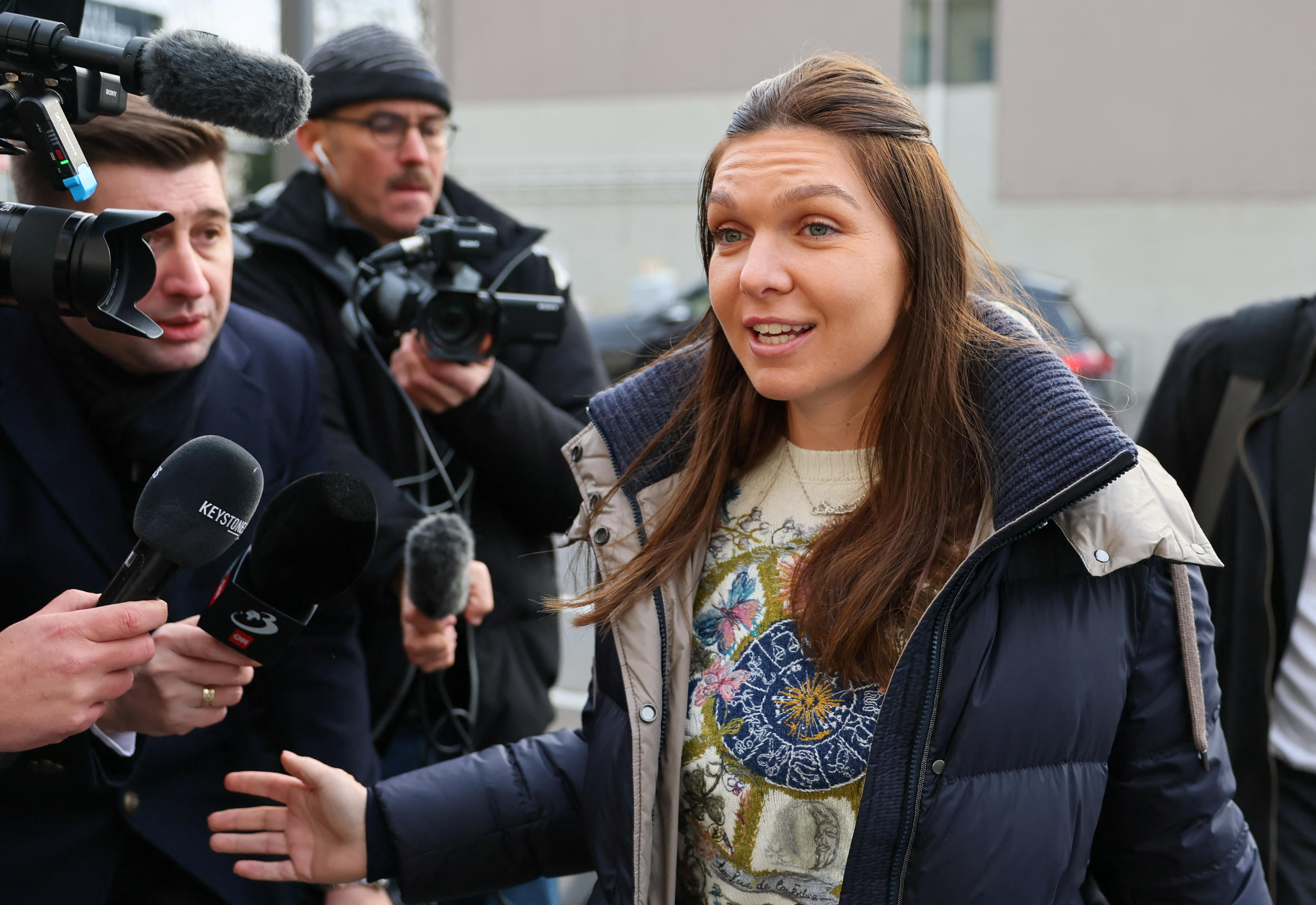 Simona Halep speaks to a crowd of media outside the Court of Arbitration for Sport
