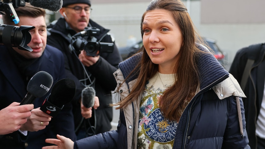 Simona Halep speaks to a crowd of media outside the Court of Arbitration for Sport