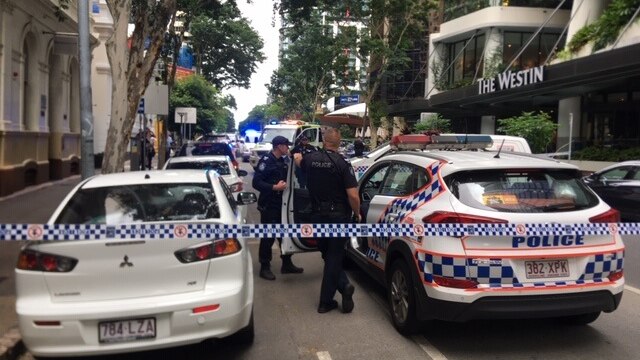 Police cordon off a city street outside a hotel
