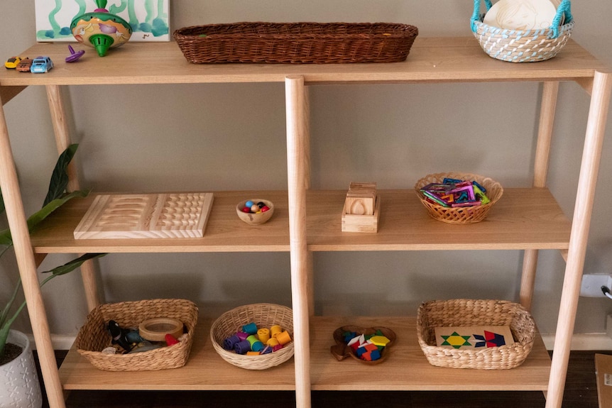 Mandy Richardson puts her children's toy in open baskets.