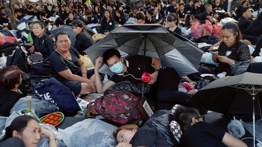 Mourners wait for tomorrow's Royal Cremation ceremony of Thailand's late King Bhumibol.