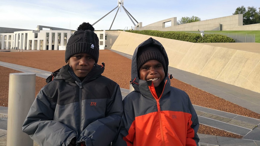 Two Aboriginal boys in front of Parliament House in Canberra.