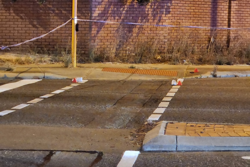 Police tape around the scene of an incident on a road