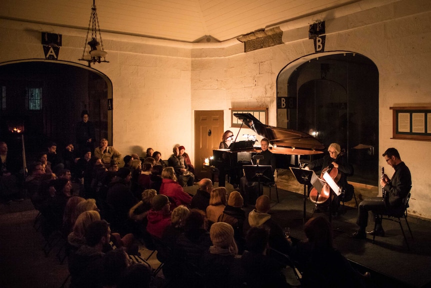 A classical music quartet performs in an old prison