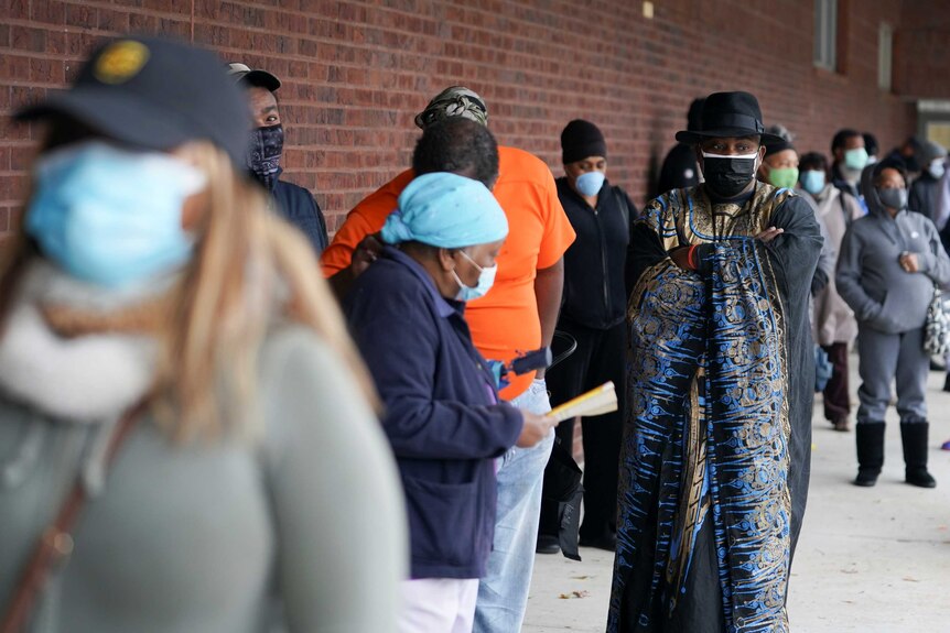Early voters queue to cast their votes