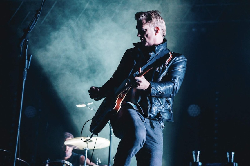 Image of josh homme on stage with his guitar at splendour in the grass 2017