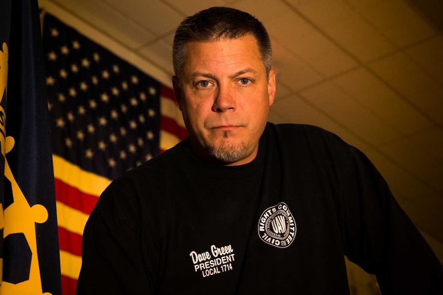 United Auto Workers 1112 President David Green looks at the camera, an America flag is behind him