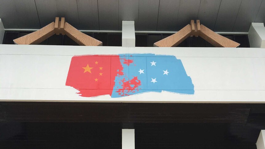 A painting on the outside of a basketball court stadium in Pohnpei blends the Chinese and Micronesian flags.