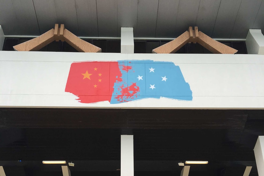 A painting on the outside of a basketball court stadium in Pohnpei blends the Chinese and Micronesian flags.