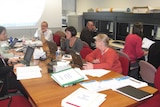 Workers at computers and desks inside Tasmania's swine flu pandemic control centre.