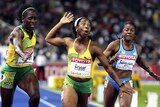 Jamaican sprinter Shelly-Ann Fraser (C) celebrates winning the the women's 100 metres final