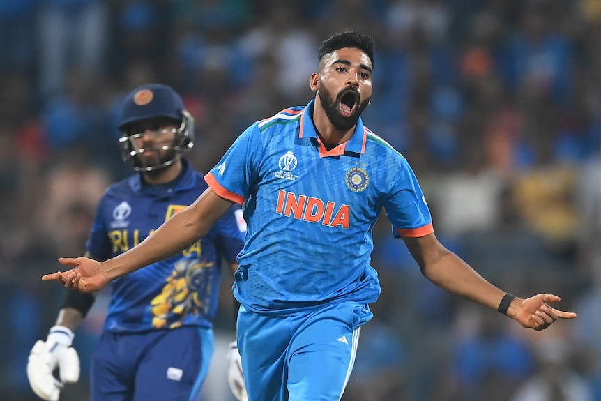 Mohammed Siraj runs away with arms outstretched after a Sri Lankan wicket at the Cricket World Cup.