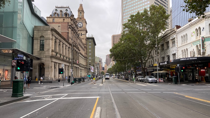 A largely empty Elizabeth Street, viewed from the tram tracks in the centre of the road.