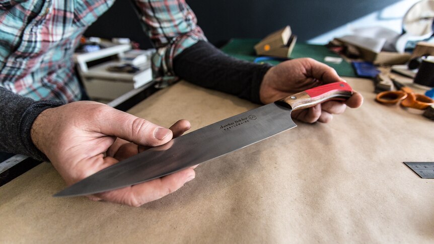 Todd Neale holding his hand-crafted knife.