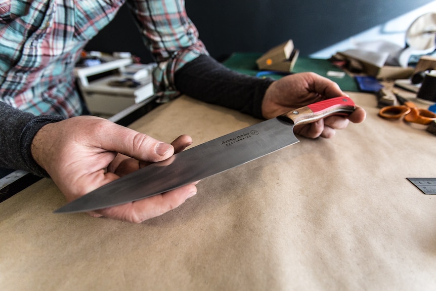 Todd Neale holding his hand-crafted knife.