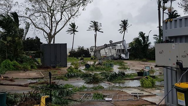 A blown-over stage and broken trees at the Ski Club.