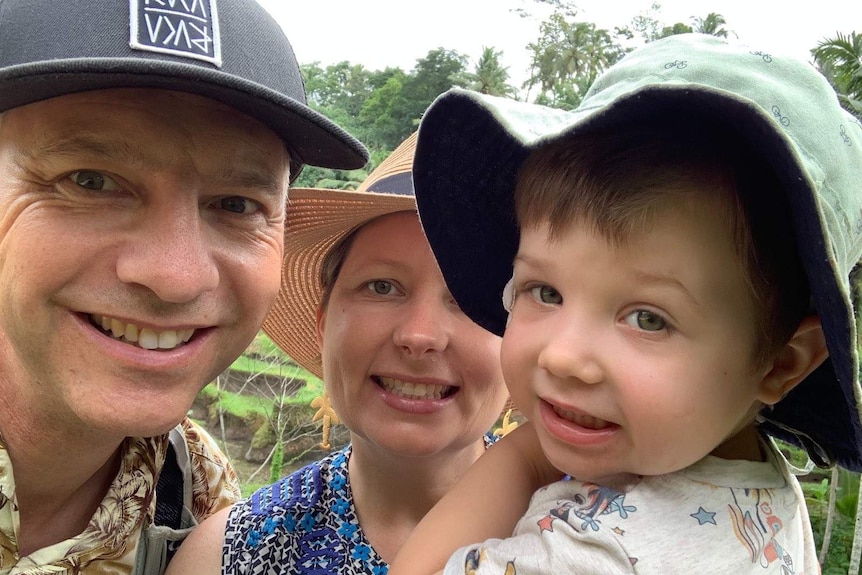 A family smile at the camera.