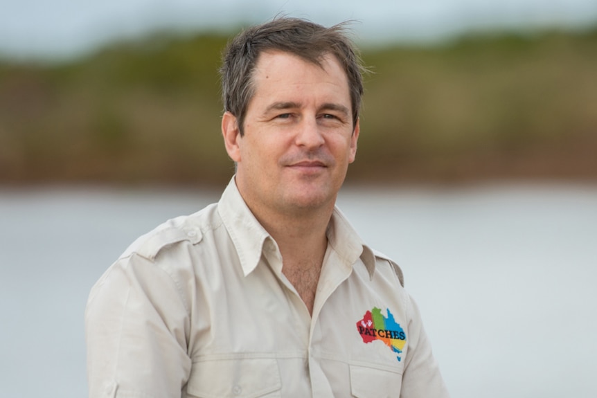 A head and shoulder shot of Dr James Fitzpatrick, with a lake in the background.