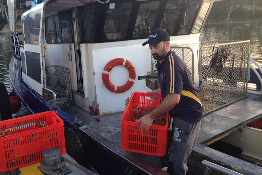 A fisherman near his vessel on a wharf