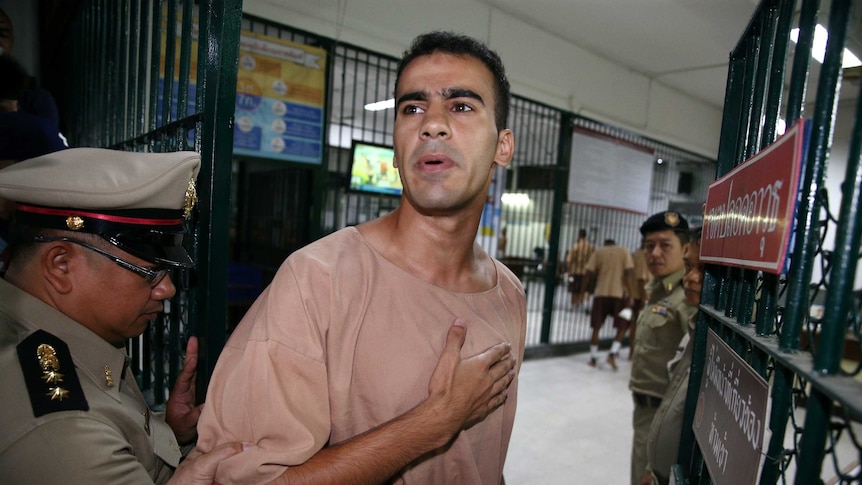 Hakeem al-Araibi gestures to his supporters outside of court in Bangkok.