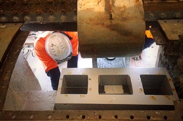 A worker navigates a tight space during the complex repair job.