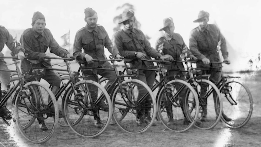 Soldiers stand with bicycles for portait photo