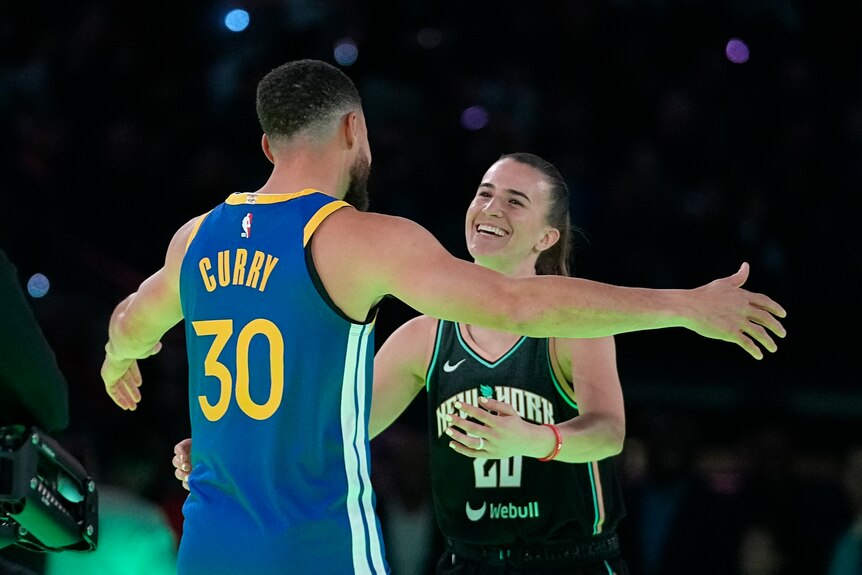 Stephen Curry hugs Sabrina Ionescu after their three-point shootout at NBA All-Star Weekend.