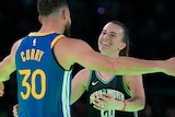 Stephen Curry hugs Sabrina Ionescu after their three-point shootout at NBA All-Star Weekend.
