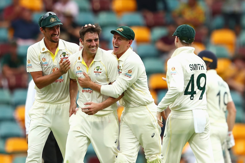 Australian captain Pat Cummins celebrates a wicket with teammates on day one of the Ashes