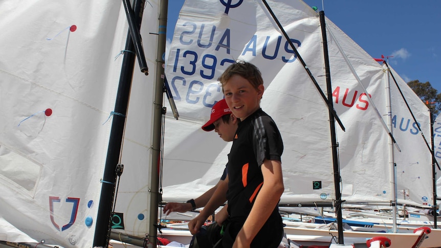 Two boys check their gear before competing on Lake Hume.