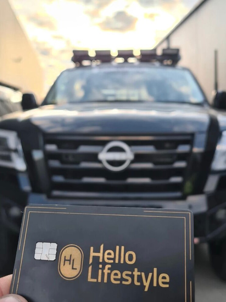 Hello Lifestyle business card with Nissan in background.