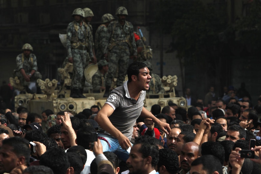 A protester on someone's shoulders yells during protests in Cairo (Reuters)