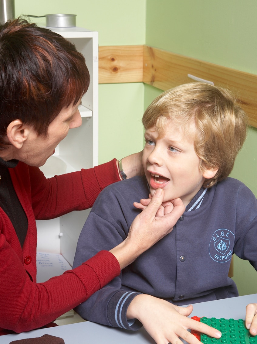 Child having a speech therapy lesson