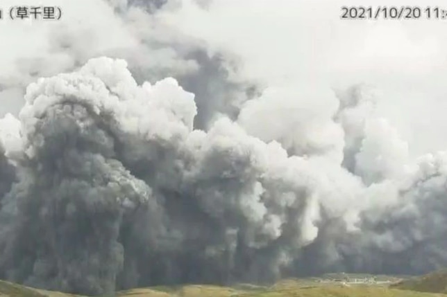 grey smoke plumes above a hill on an overcast day 