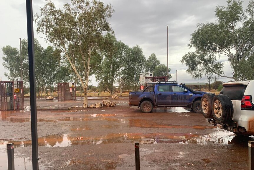 The roadhouse carpark, with puddles and a few cars