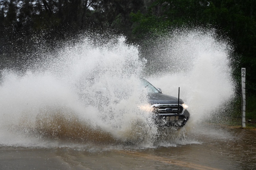 A car surrounded by a large splash.