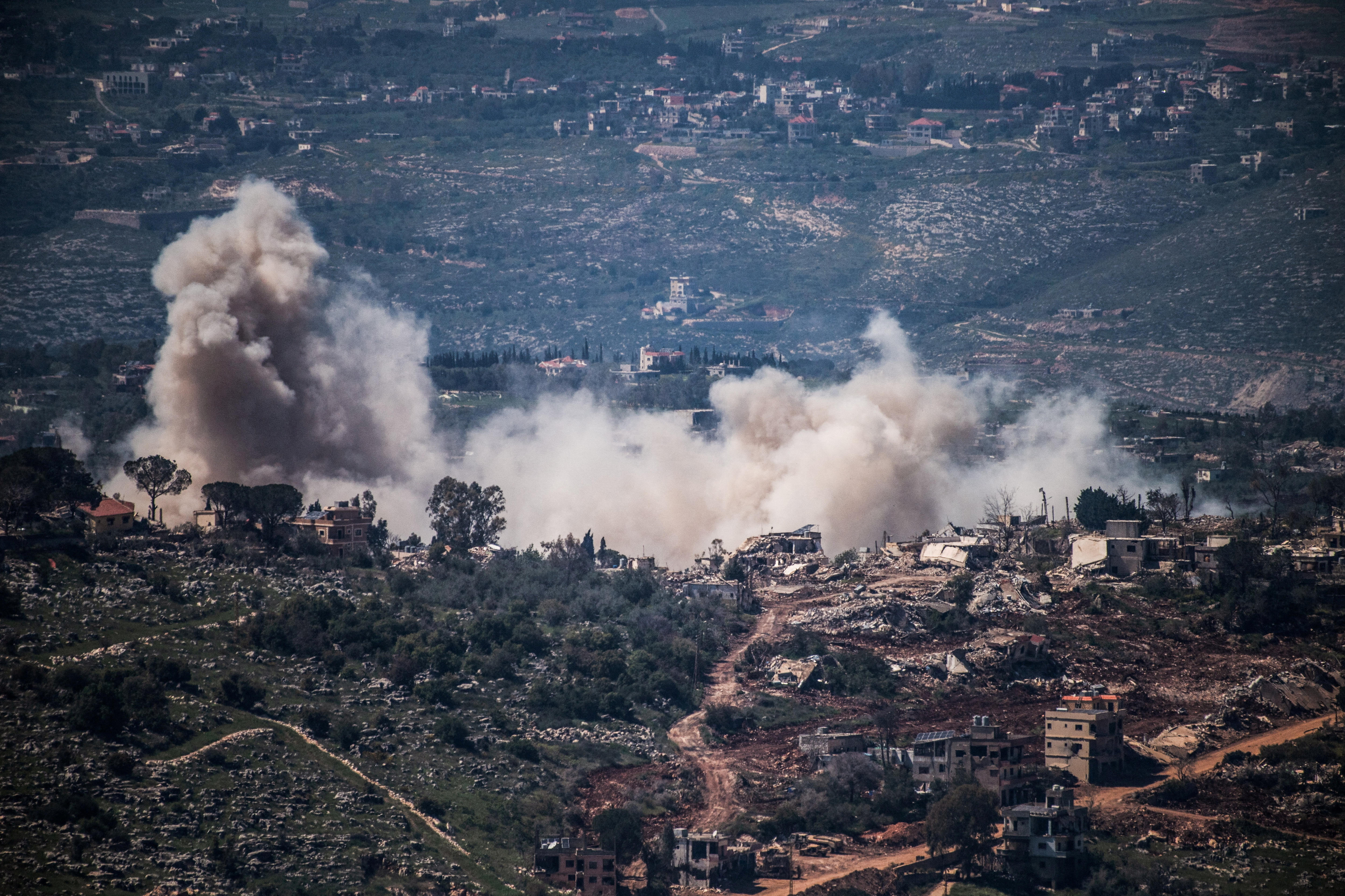 Smoke rises from a village in southern Lebanon as the Israeli army operates tanks in the area