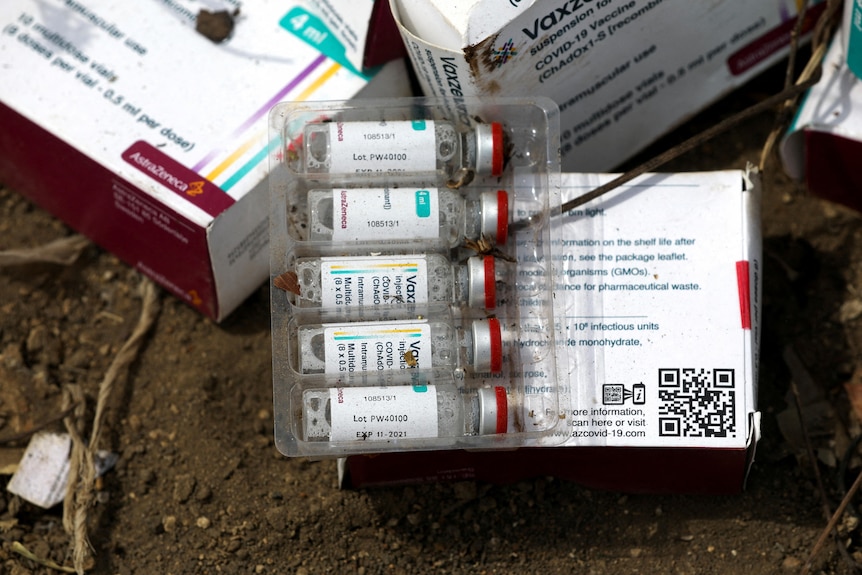 An expired package of COVID-19 vaccine at a dump site.