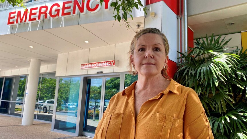 A woman stands outside the Cairns Hospital Emergency Department
