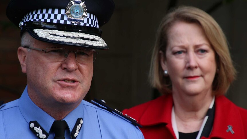 The police commissioner speaks as police minister Michelle Roberts looks on from behind.
