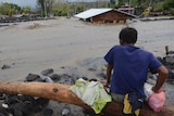 A man looks as floodwaters inundate an area as Typhoon Goni hit Daraga.