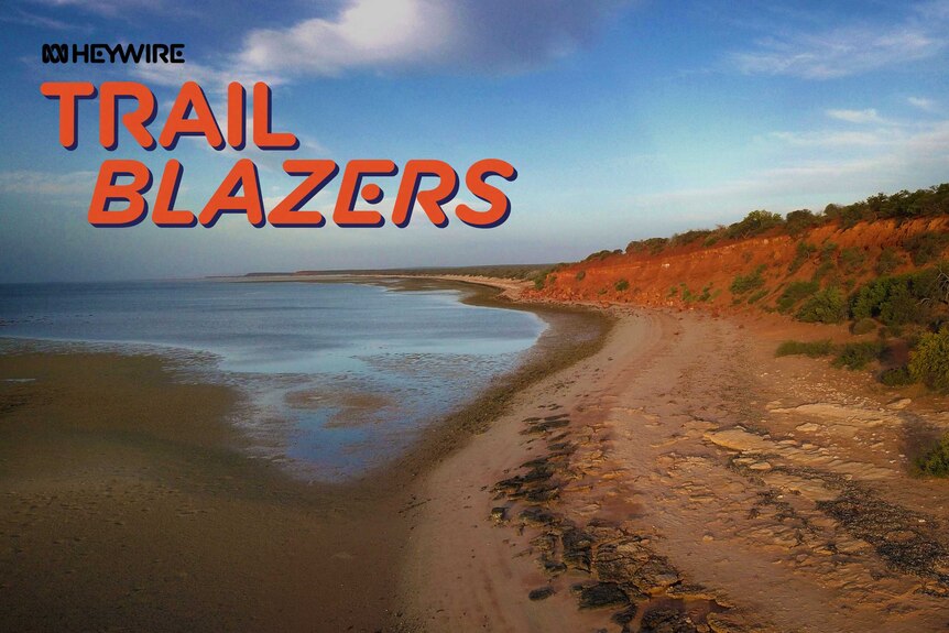 Water is seen to the left of the image with red dirt and a small cliff on the right. ABC and Trailblazer logos on left.