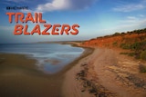 Water is seen to the left of the image with red dirt and a small cliff on the right. ABC and Trailblazer logos on left.