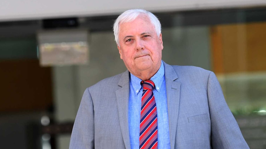 Clive Palmer, dressed in a suit, leaving the Supreme Court in Brisbane
