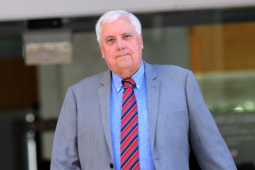 Clive Palmer, dressed in a suit, leaving the Supreme Court in Brisbane