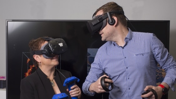 Two people with virtual reality headsets on their heads